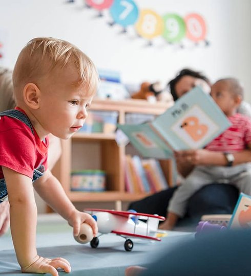 baby crawling playing with toys